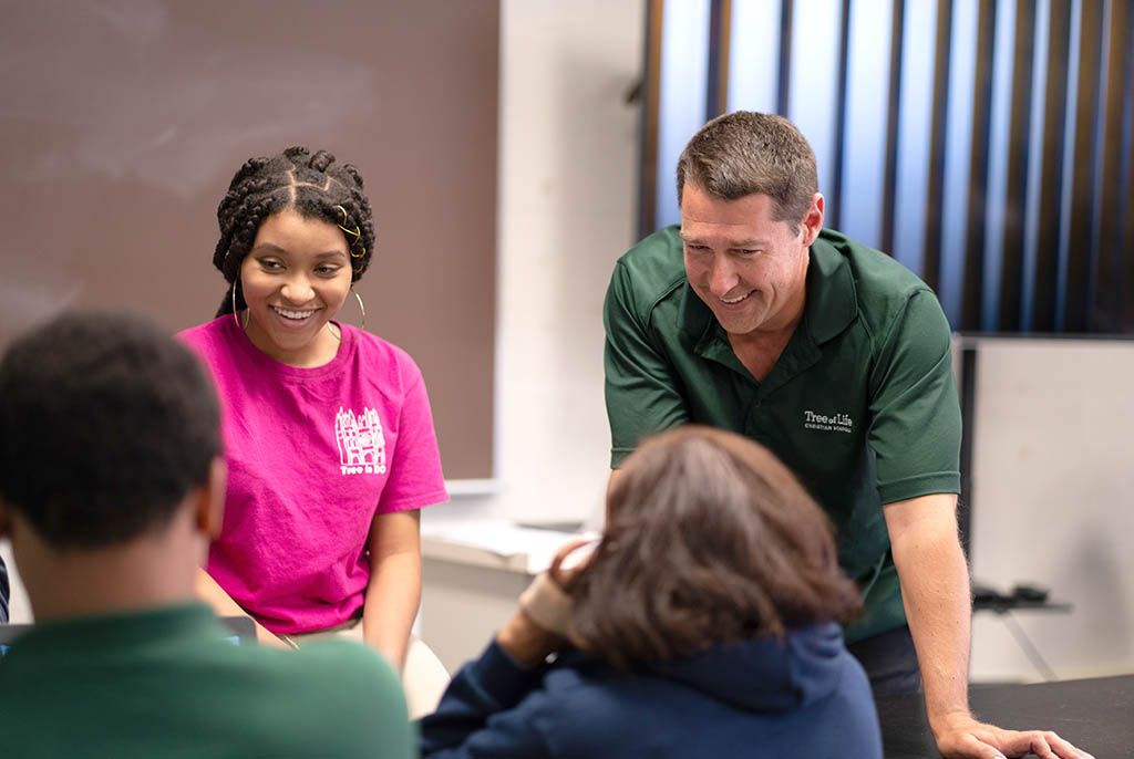 teacher laughing with students