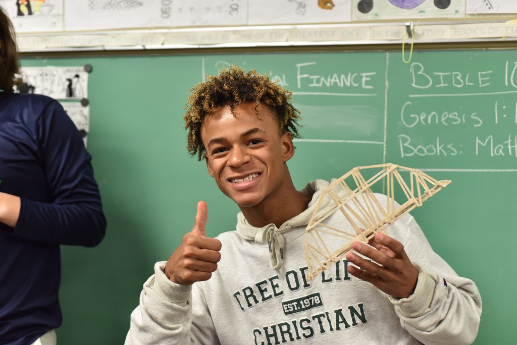 student with wood bridge project