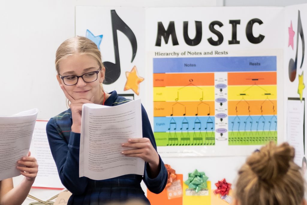 student in music room performing in class