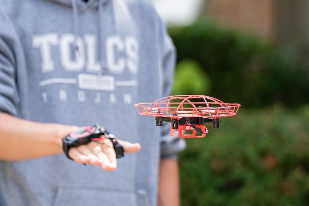student flying drone