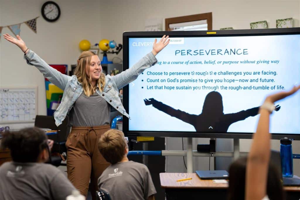 Teacher extending hands in classroom